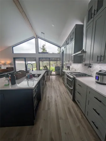 a kitchen with stainless steel appliances granite countertop a stove and cabinets