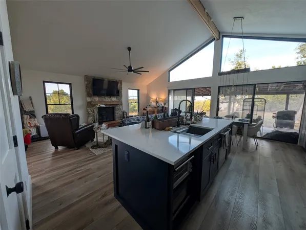 a kitchen with a stove and a wooden floor