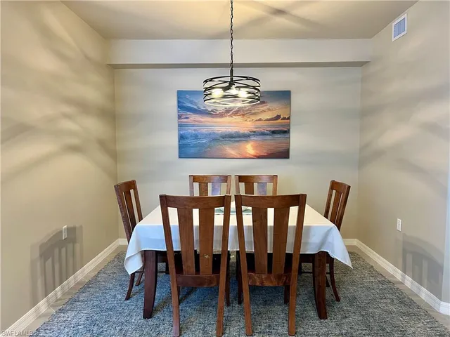 a view of a dining room with furniture wooden floor and a chandelier