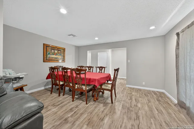 a view of a dining room with furniture and wooden floor