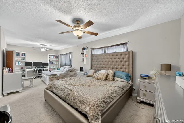 a bedroom with a bed couch and a window