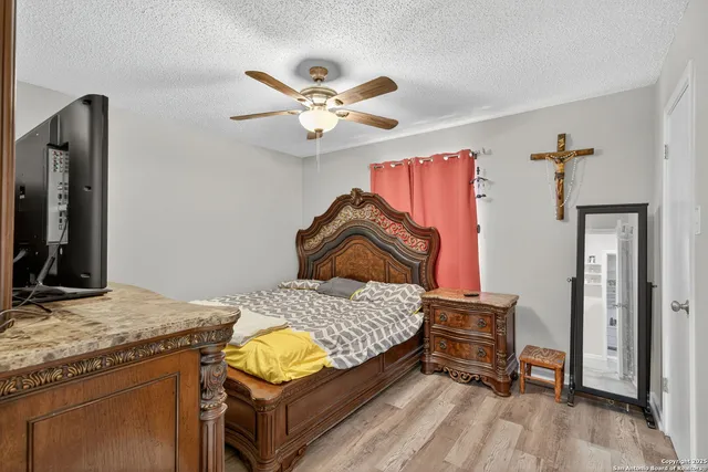 a bedroom with a bed and a chandelier