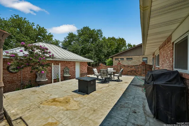 a view of a patio with table and chairs and potted plants