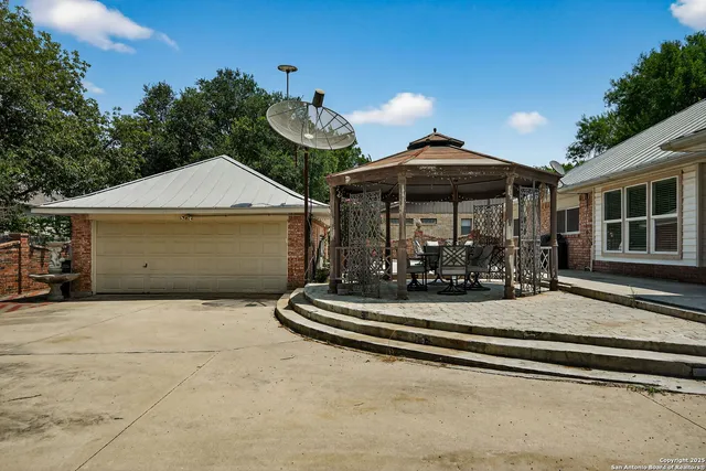 a front view of a house with a yard outdoor seating and garage