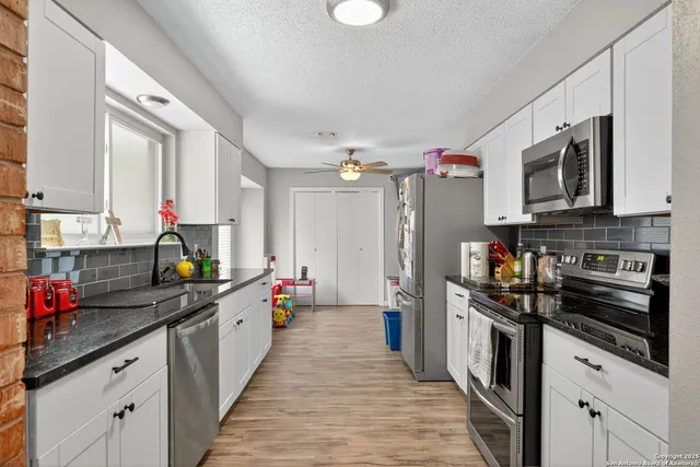 a kitchen that has a lot of cabinets