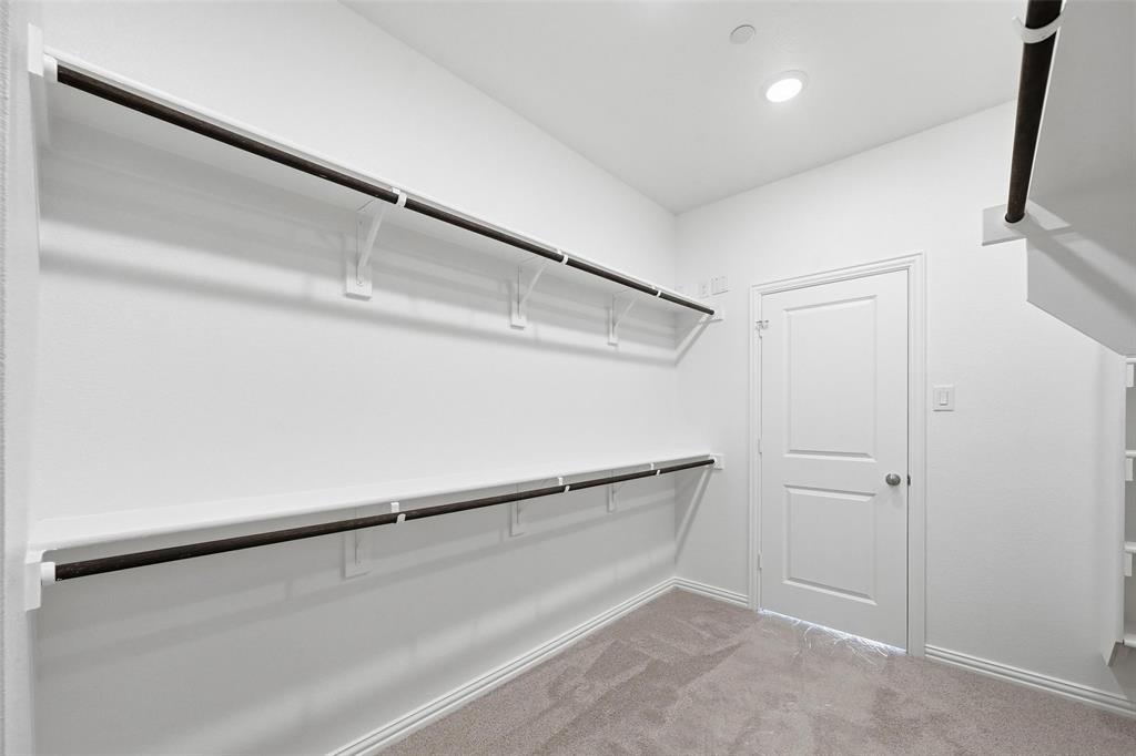 1168 Daybreak Drive, Unit 1168 Allen, TX 75013 - Photo 15 of 25 Built-in shelving with hanging rods, recessed ceiling lighting, and neutral carpeting