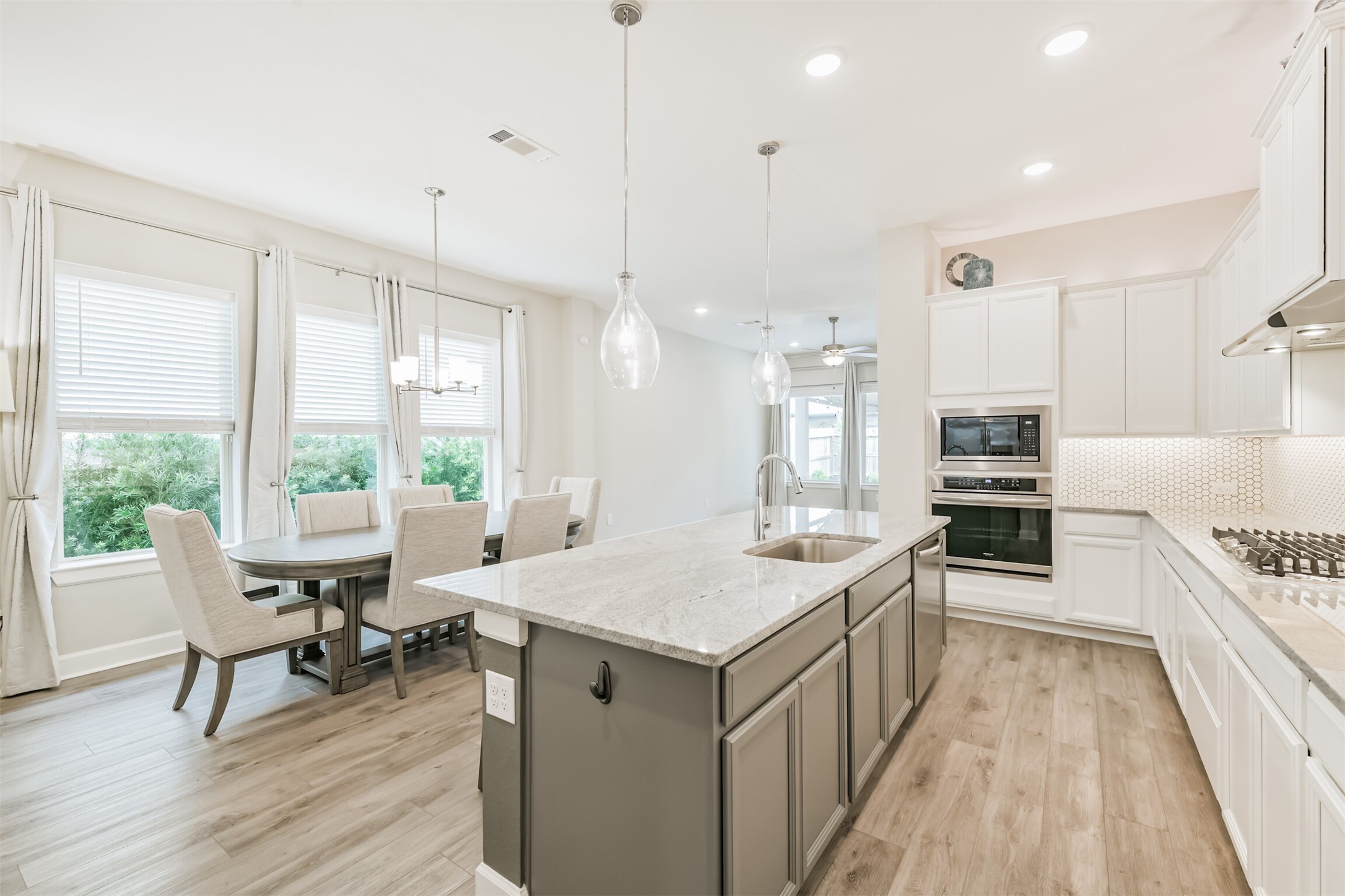 15611 Rising Wren Court Conroe, TX 77302 - Photo 10 of 38 a large kitchen with kitchen island a large island in it