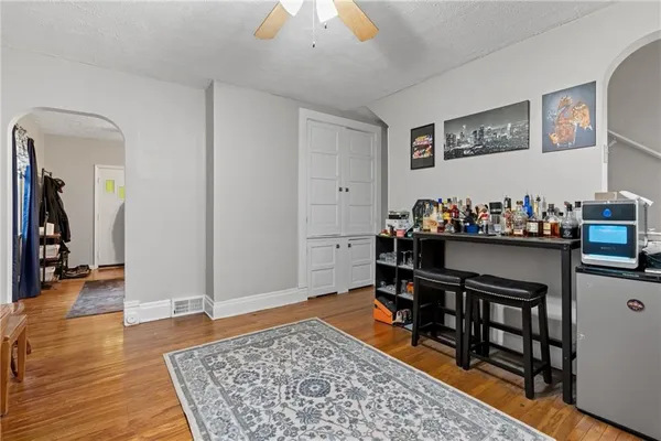 a living room with furniture and wooden floor