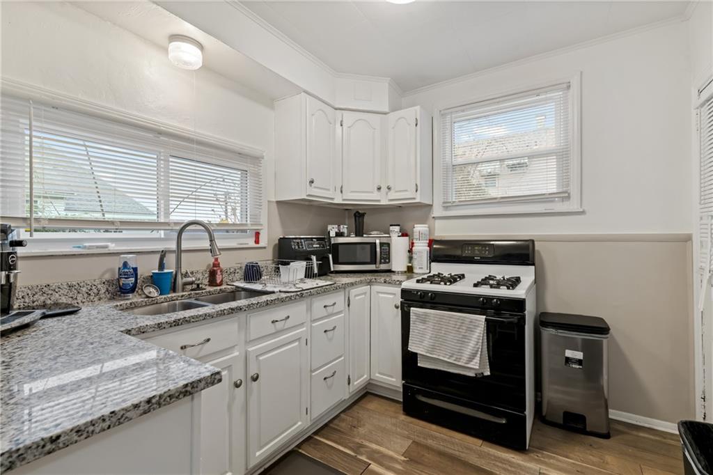821 George Street Coraopolis, PA 15108 - Photo 8 of 18 a kitchen with a sink stove top oven and cabinets