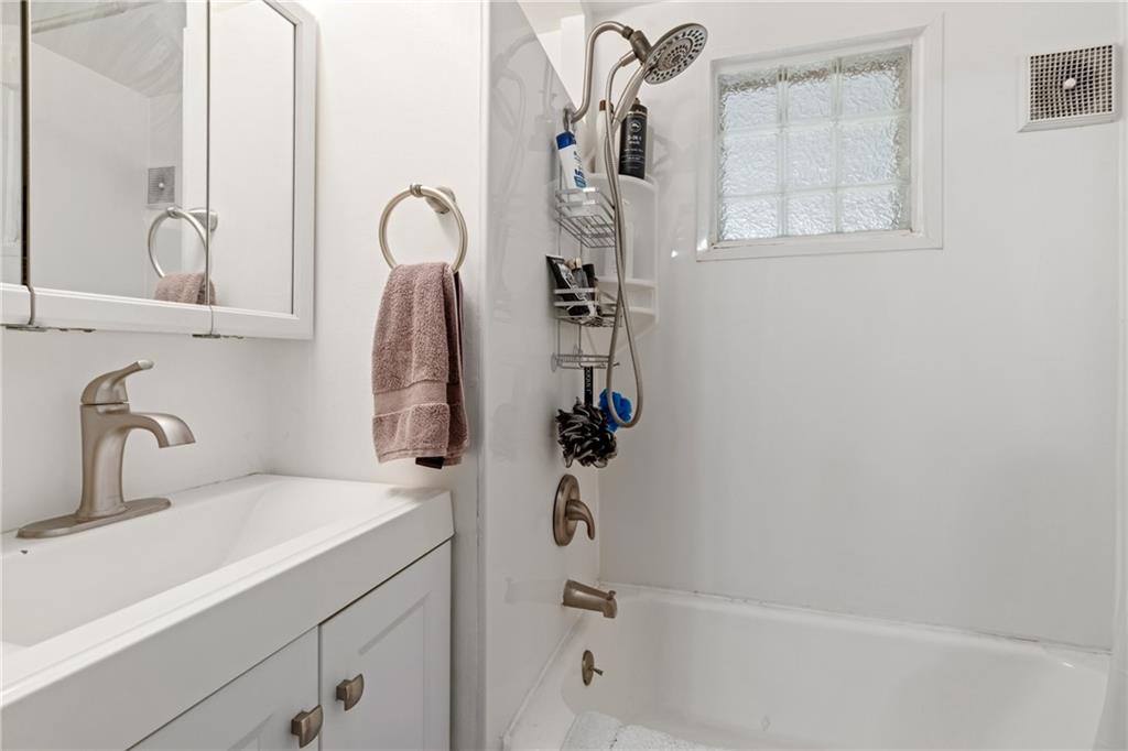 821 George Street Coraopolis, PA 15108 - Photo 10 of 18 a bathroom with a shower sink and mirror