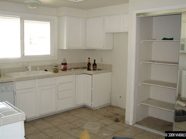2702 Harding Way Reno, NV 89503 - Photo 3 of 4 a kitchen with white cabinets and white appliances