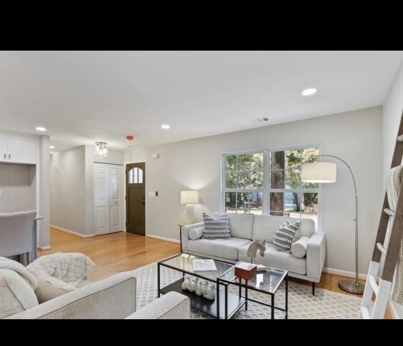 5115 Martins Crossing Road Stone Mountain, GA 30088 - Photo 2 of 9 a living room with furniture and a large window
