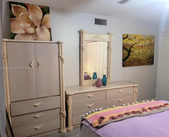 a bedroom with a bed and a cabinets