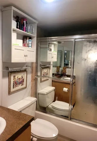 a bathroom with a toilet a sink and a mirror