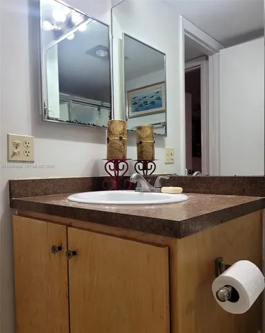 a bathroom with a sink a mirror and a toilet