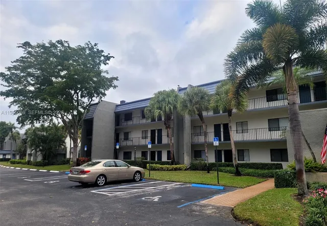 a cars parked in front of a brick house next to a yard