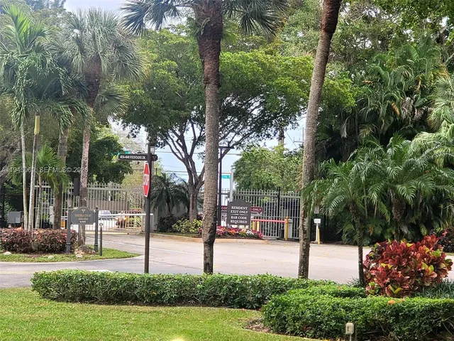 a swimming pool with garden and tall trees