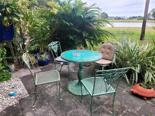 a backyard of a house with table and chairs