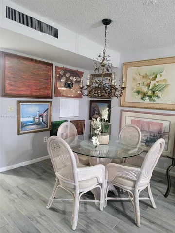 a dining room with furniture and chandelier