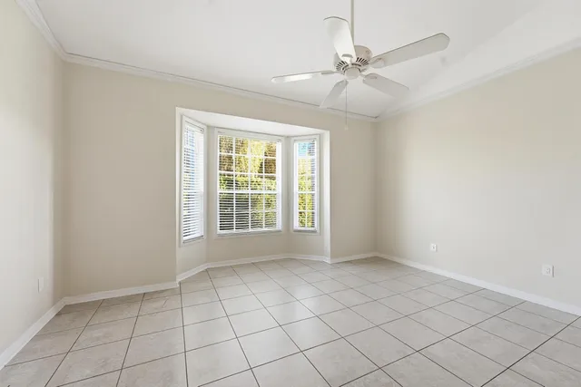 an empty room with fan and entryway