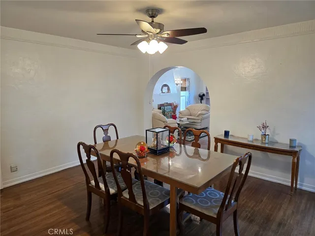 a view of a dining room with furniture and a chandelier fan