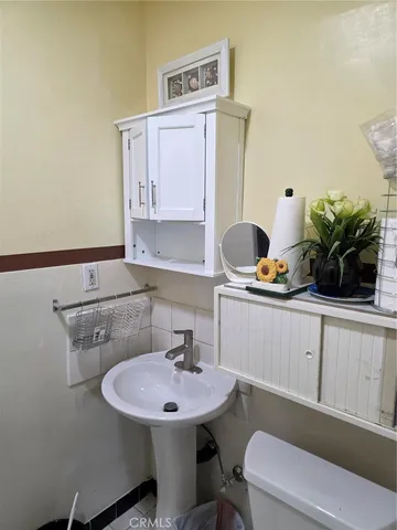 a bathroom with a sink a toilet and mirror