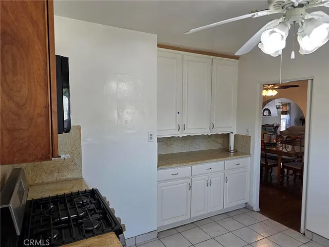 a kitchen with white cabinets and appliances