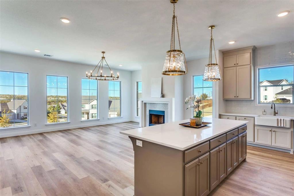 8965 Armstrong Court Benbrook, TX 76126 - Photo 22 of 24 a kitchen that has a lot of cabinets in it and wooden floors