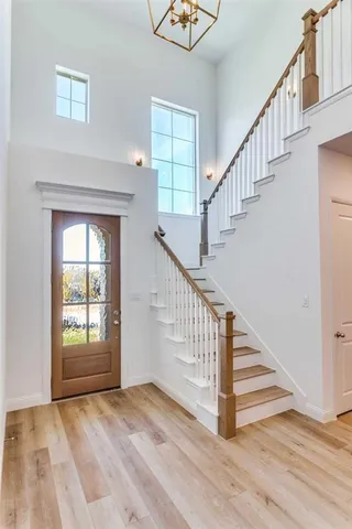 a view of staircase with white walls and a window
