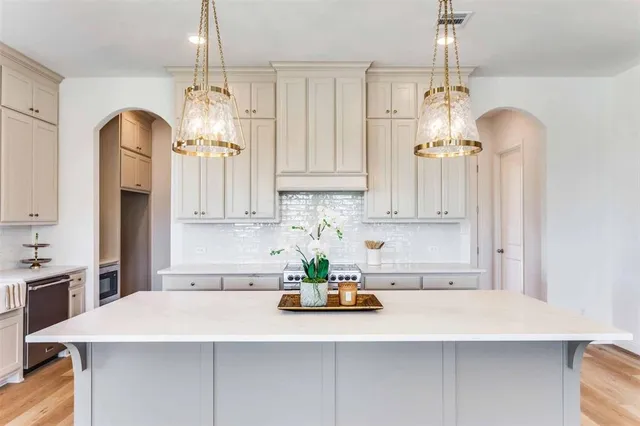 a kitchen with kitchen island granite countertop a sink a center island and cabinets