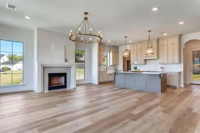 a bathroom with a granite countertop bathtub sink vanity mirror and toilet