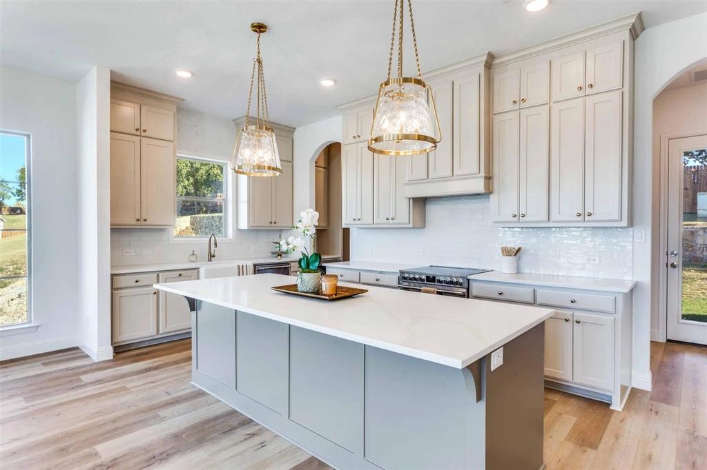8965 Armstrong Court Benbrook, TX 76126 - Photo 5 of 24 a kitchen with stainless steel appliances granite countertop a sink a stove and a wooden floors