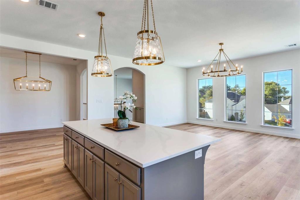 8965 Armstrong Court Benbrook, TX 76126 - Photo 6 of 24 a kitchen that has a lot of cabinets and a wooden floor