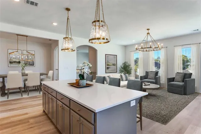 an empty room with wooden floor fireplace and windows
