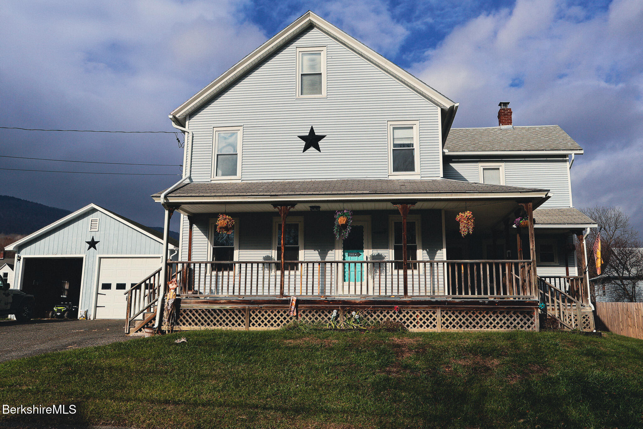 a front view of a house with a garden