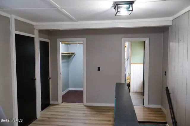 a view of a hallway with wooden floor and staircase
