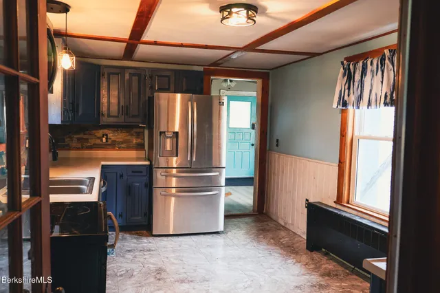 a kitchen with refrigerator and window