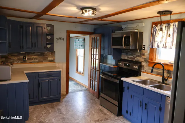 a kitchen with wooden cabinets and black appliances