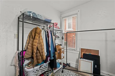 a view of walk in closet with clothes