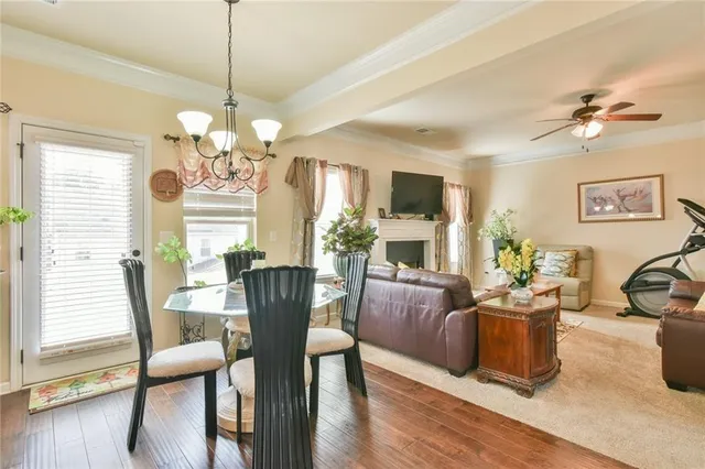 a view of a dining room with furniture wooden floor and chandelier