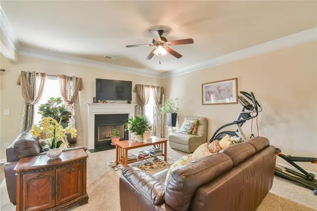 a living room with furniture a fireplace and a flat screen tv