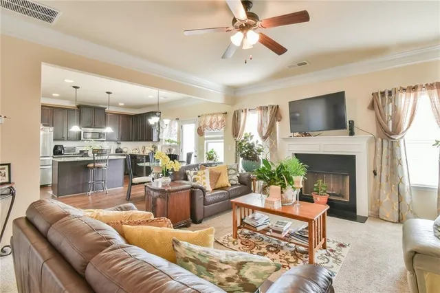 a living room with furniture a fireplace and a flat screen tv
