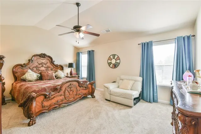 a spacious bedroom with a bed and a couch