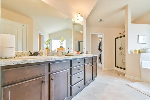 a spacious bathroom with a granite countertop sink mirror and a