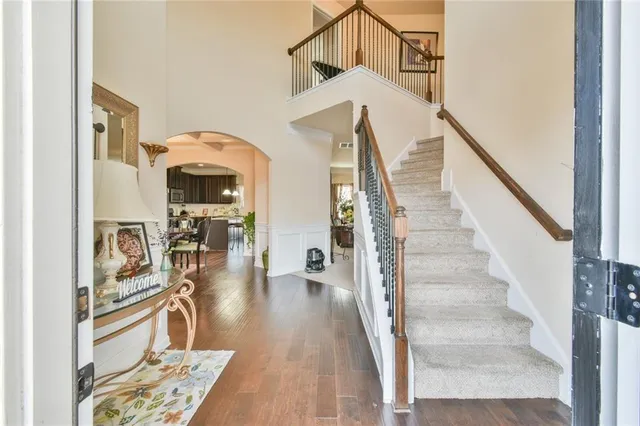 a view of entryway and hall with wooden floor