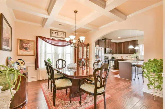 a view of a dining room with furniture and chandelier