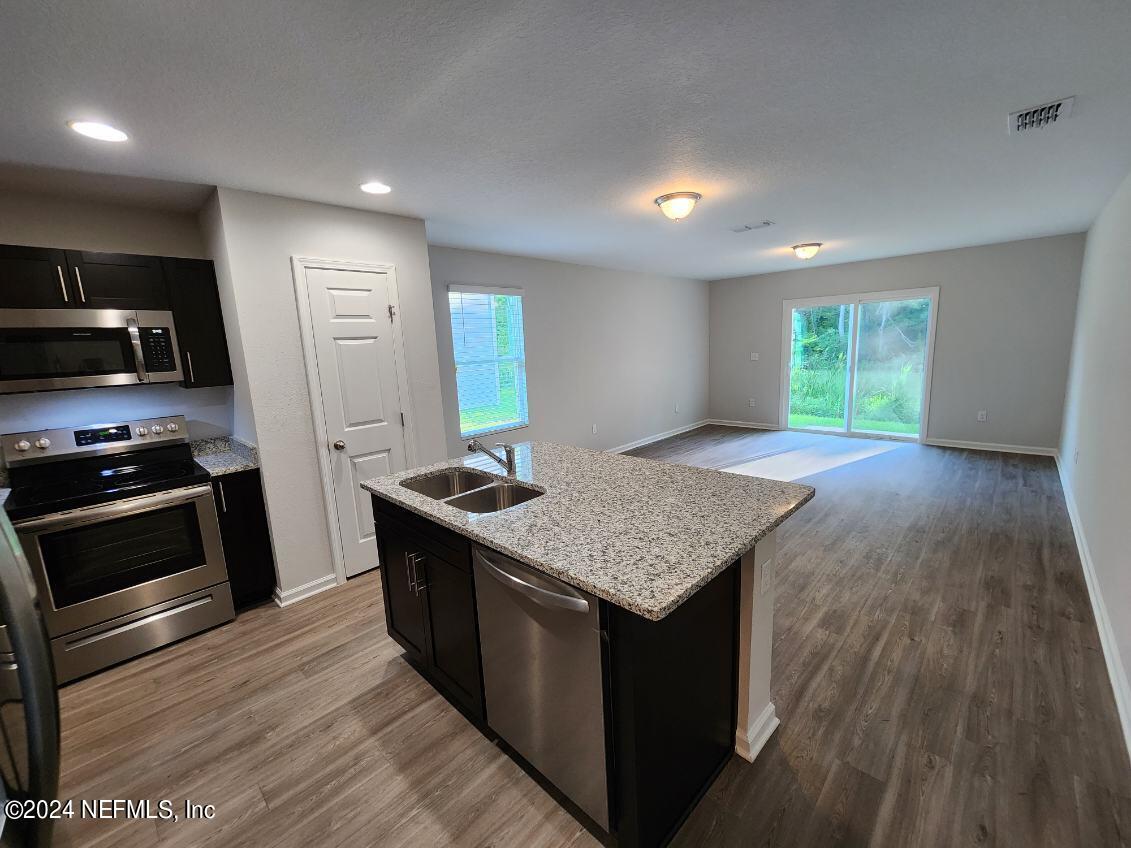 1288 Ellis Road South Jacksonville, FL 32205 - Photo 13 of 14 a kitchen with a stove and a wooden floors