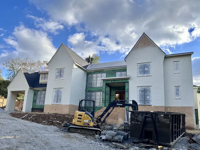 a view of a house with backyard space and balcony