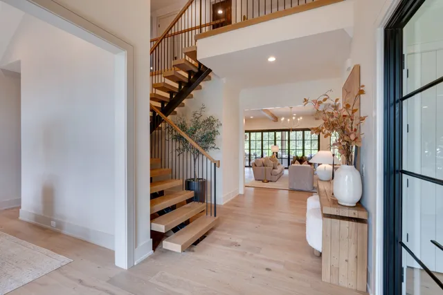 a view of entryway and hall with wooden floor