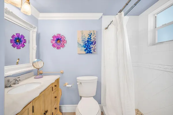 a bathroom with a sink toilet and mirror
